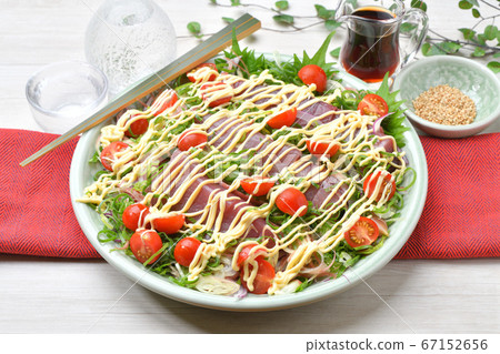 Katsuo sashimi, mayonnaise salad style arrangement. Spicy bonito sashimi with plenty of vegetables such as leeks and cherry tomatoes 67152656