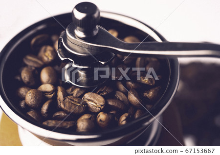 Coffee bean roasted in wooden grinder. 67153667
