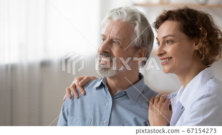 Smiling female nurse dream of healthy future with senior patient Smiling female nurse dream of healthy future with senior patient 67154273