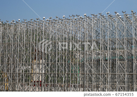 KUALA LUMPUR, MALAYSIA -JULY 29, 2019: Scaffolding is installed on the construction site as temporary support for high level construction. Installed according to specifications to ensure workers safet KUALA LUMPUR, MALAYSIA -JULY 29, 2019: Scaffolding is installed on the construction site as temporary support for high level construction. Installed according to specifications to ensure workers safet 67154355
