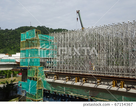 KUALA LUMPUR, MALAYSIA -JULY 29, 2019: Scaffolding is installed on the construction site as temporary support for high level construction. Installed according to specifications to ensure workers safet KUALA LUMPUR, MALAYSIA -JULY 29, 2019: Scaffolding is installed on the construction site as temporary support for high level construction. Installed according to specifications to ensure workers safet 67154367