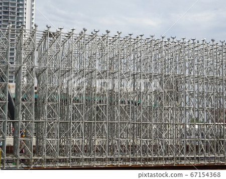 KUALA LUMPUR, MALAYSIA -JULY 29, 2019: Scaffolding is installed on the construction site as temporary support for high level construction. Installed according to specifications to ensure workers safet 67154368