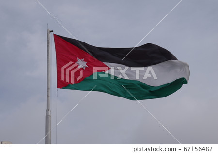 [Jordan] Irbid, Jordan flag fluttering in cloudy sky 67156482