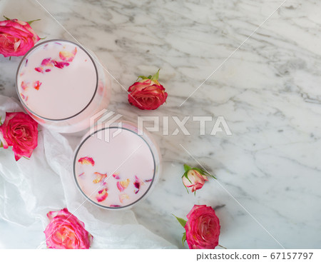 Moon milk prepares with pink rose flower. Trendy 67157797
