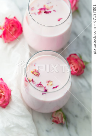Moon milk prepares with pink rose flower. Trendy 67157801