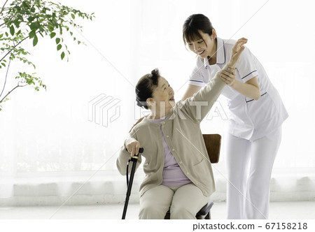 Caregiver helping rehabilitation 67158218