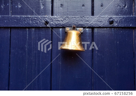 Traditional old door bell for ring on old wooden door, vintage background textue Traditional old door bell for ring on old wooden door, vintage background textue 67158256