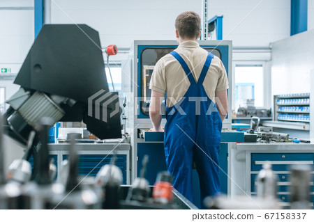 Man working in factory on semi automatized production line Man working in factory on semi automatized production line 67158337