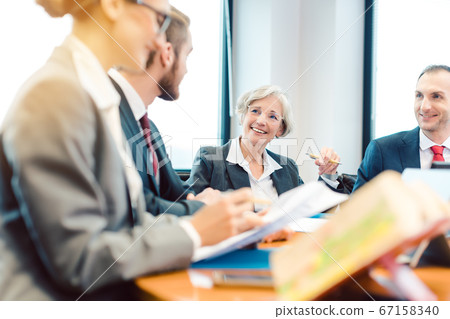 Lawyers working on a contract in their law firm Lawyers working on a contract in their law firm 67158340