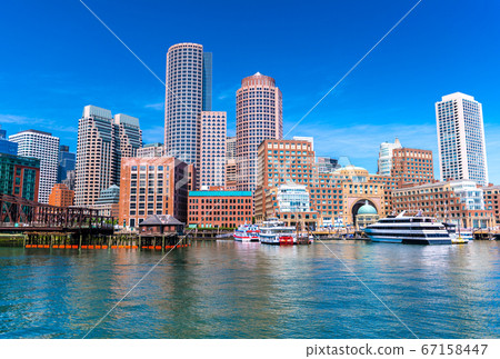 Boston cityscape reflected in the water, skyscrapers and office buildings in downtown, USA 67158447