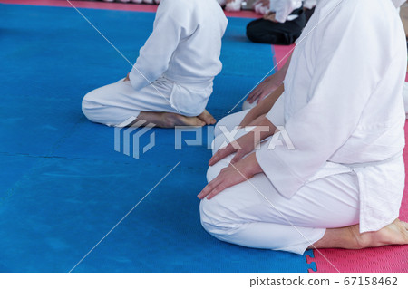 Children in kimono and yellow belts sitting on tatami 67158462