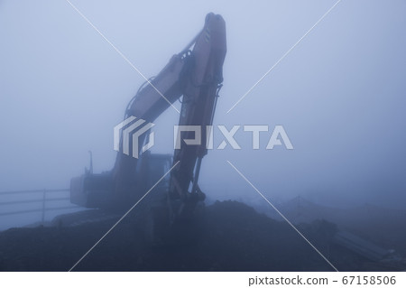 Foggy day and excavator 67158506