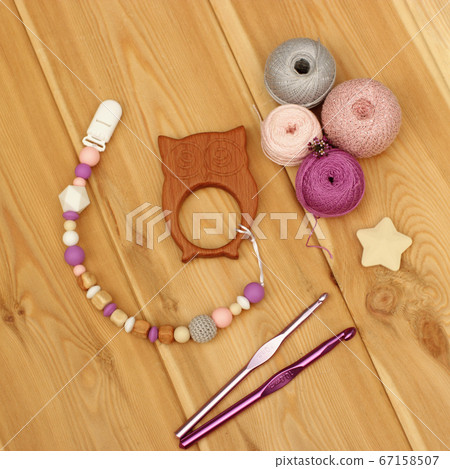 crocheted baby pacifier holder. Yarn balls and crocheted baby pacifier holder. Yarn balls and 67158507