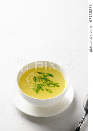 Chicken broth isolated in white table. Copy space. Chicken broth isolated in white table. Copy space. 67158876
