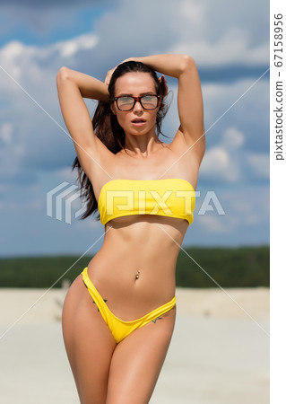 Beautiful woman in swimsuit on beach Beautiful woman in swimsuit on beach 67158956
