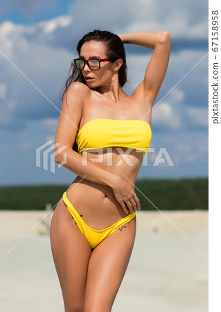 Beautiful woman in swimsuit on beach Beautiful woman in swimsuit on beach 67158958