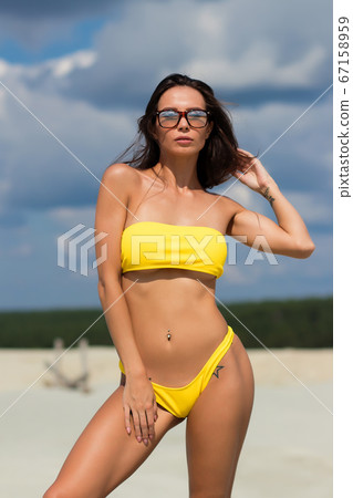 Beautiful woman in swimsuit on beach Beautiful woman in swimsuit on beach 67158959