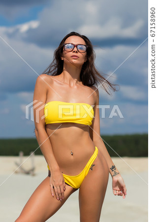 Beautiful woman in swimsuit on beach Beautiful woman in swimsuit on beach 67158960