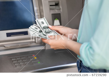 Unrecognizable Female Counting Dollar Money Cash Near ATM Machine Unrecognizable Female Counting Dollar Money Cash Near ATM Machine 67159290