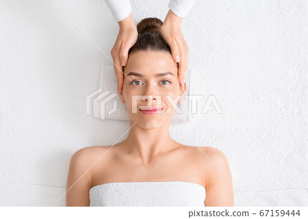 Pretty young lady getting head massage at spa Pretty young lady getting head massage at spa 67159444