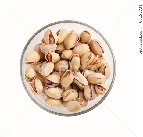 Nuts for snack. Pistachios in glass plate isolated on white background Nuts for snack. Pistachios in glass plate isolated on white background 67159731