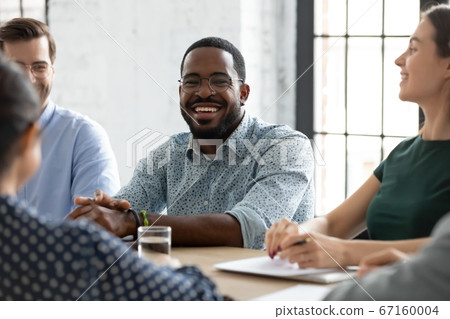 African team leader enjoy positive communication during briefing with workmates African team leader enjoy positive communication during briefing with workmates 67160004