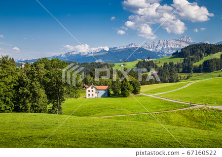 Idyllic landscape in the Swiss Alps with Saentis mountain peak in the background in summer 67160522