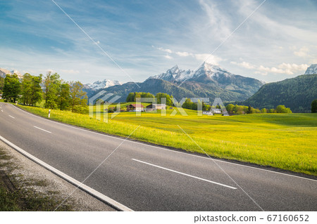 Empty asphalt country road with alpine mountain landscape in summer 67160652