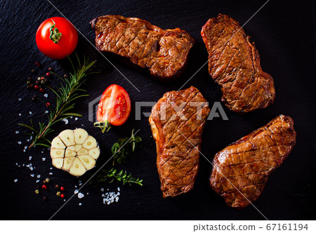Mouthwatering slices of steak cooked for a picnic Mouthwatering slices of steak cooked for a picnic 67161194