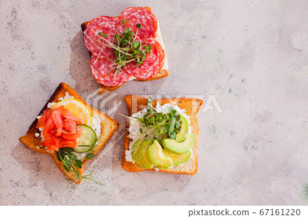 Close-up three sandwiches with various contains on light murble surface Close-up three sandwiches with various contains on light murble surface 67161220