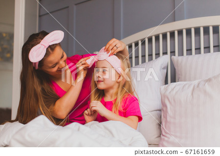 Mom and daughter are engaged in their beauty after waking up Mom and daughter are engaged in their beauty after waking up 67161659