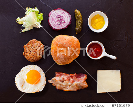 Top view burger components on black background 67161679