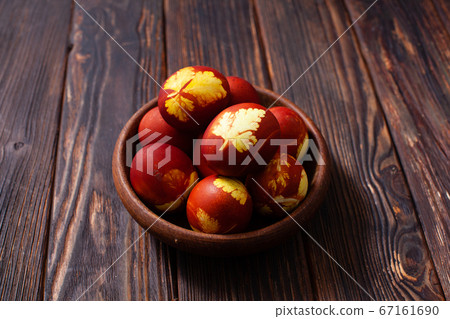 Wooden bowl with plant pattern colored eggs 67161690