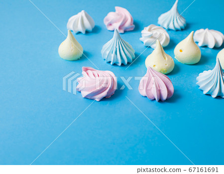 Delicious aerial meringue cookies on blue surface 67161691