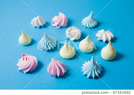 Top view colorful meringue cookies on blue background Top view colorful meringue cookies on blue background 67161692