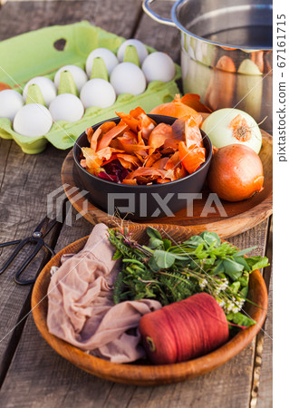 Preparation of Easter eggs colouring in family traditions 67161715