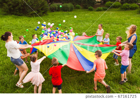 Birthday games on fresh air with parachute and balls 67161725