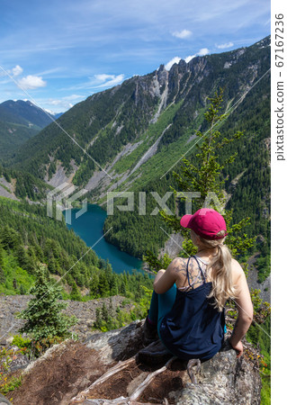 Girl on Top of Cliff with Beautiful View of Canadian Mountain Landscape 67167236