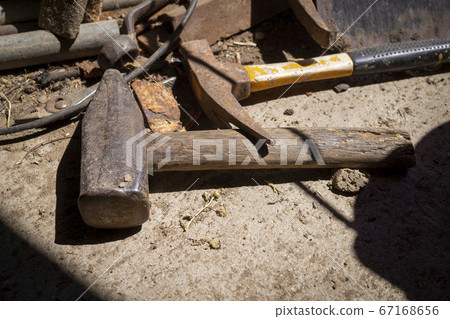 Rusty tools lying on an old dusty workbench Rusty tools lying on an old dusty workbench 67168656