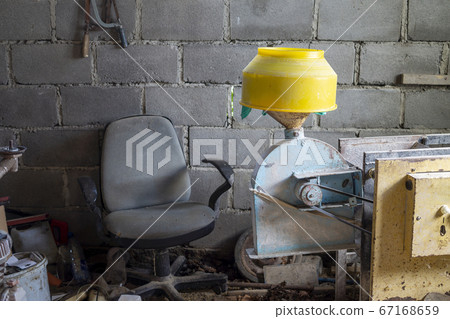 Old broken armchair with factory equipment 67168659