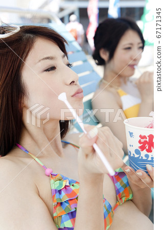A woman eating shaved ice A woman eating shaved ice 67171345