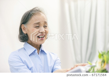 Senior woman talking on landline phone Senior woman talking on landline phone 67171564
