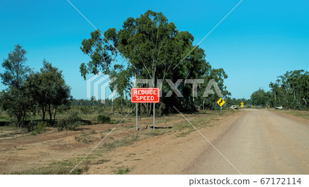 Reduce speed sign and arrows on dusty unsealed 67172114