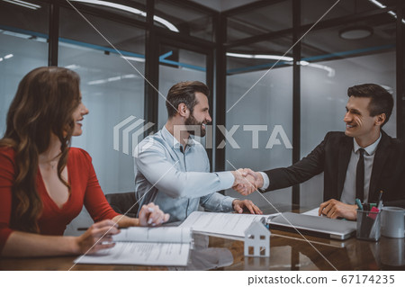 Young couple buying a new apartment at the sellers office 67174235