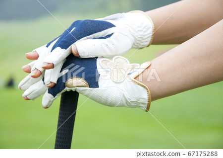 Woman hand holding golf club Woman hand holding golf club 67175288