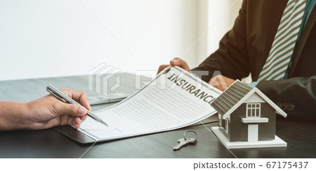 The buyer is signing a contract for business rental, mortgage purchase, or home insurance in front of a real estate agent The buyer is signing a contract for business rental, mortgage purchase, or home insurance in front of a real estate agent 67175437