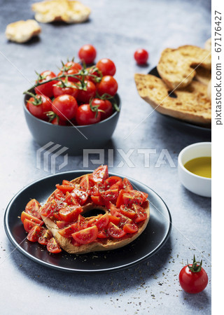 Friselle with tomato, oil and origano Friselle with tomato, oil and origano 67176427