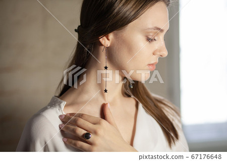 Portrait of beautiful fair young woman with jewelry, one light source Portrait of beautiful fair young woman with jewelry, one light source 67176648