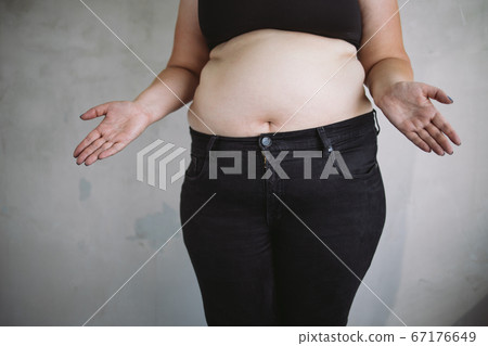 Overweight bewildered woman throwing up hands 67176649