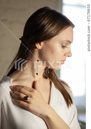 Portrait of beautiful fair young woman with jewelry, one light source Portrait of beautiful fair young woman with jewelry, one light source 67176650